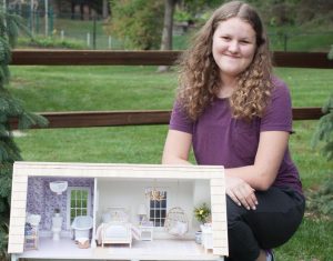 Ella poses with one of her creations! Photo Courtesy of Ella Doyle